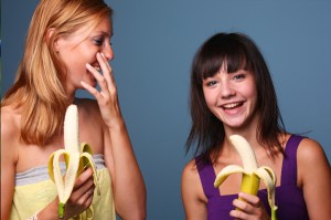 happy-woman-eating-bananas